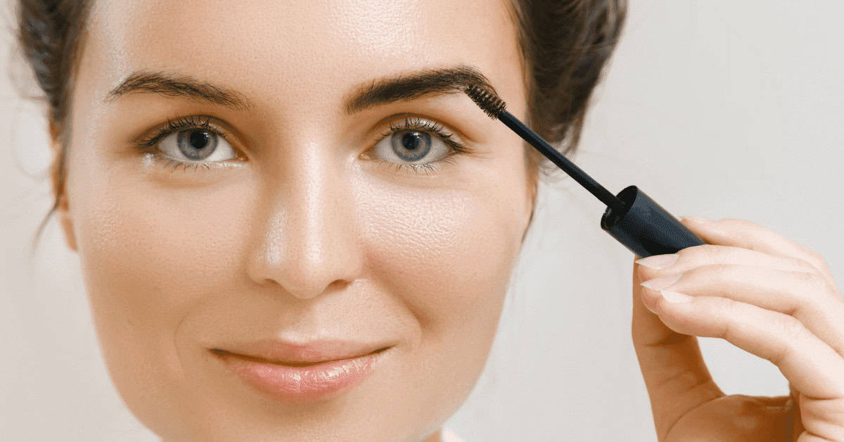 What Does Tinted Eyebrow Gel Do Silky black mascara being applied to woman's eyelashes, enhancing eye makeup for a polished look.