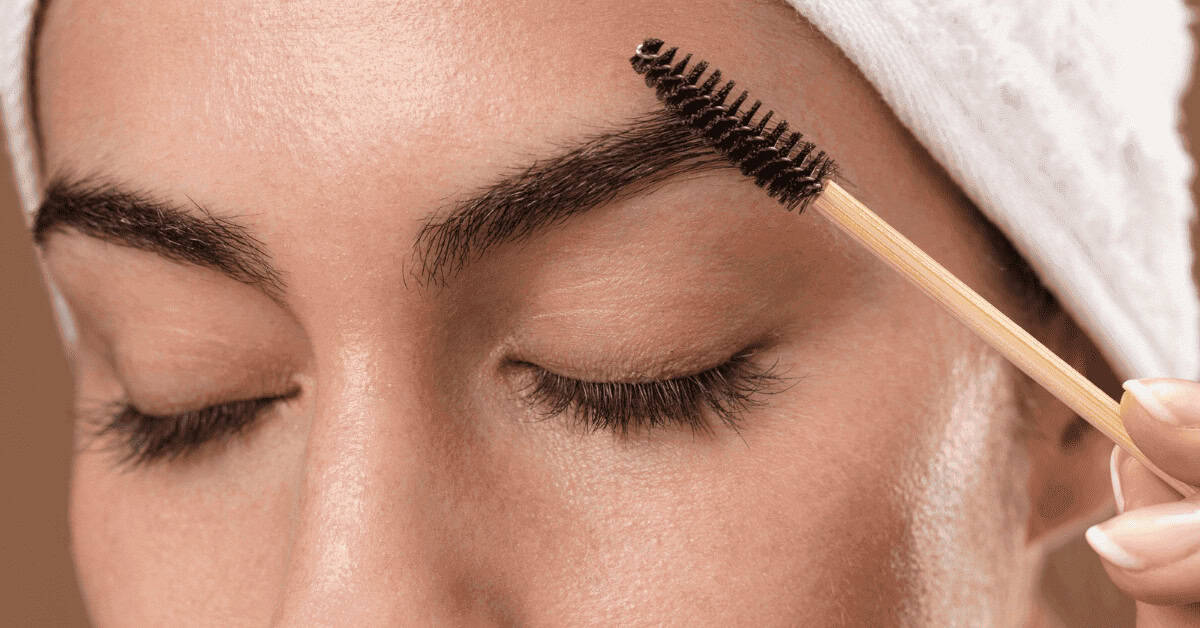 Brush applying mascara on eyelash, close-up of eye makeup, beauty and cosmetics, Dappered Chic.