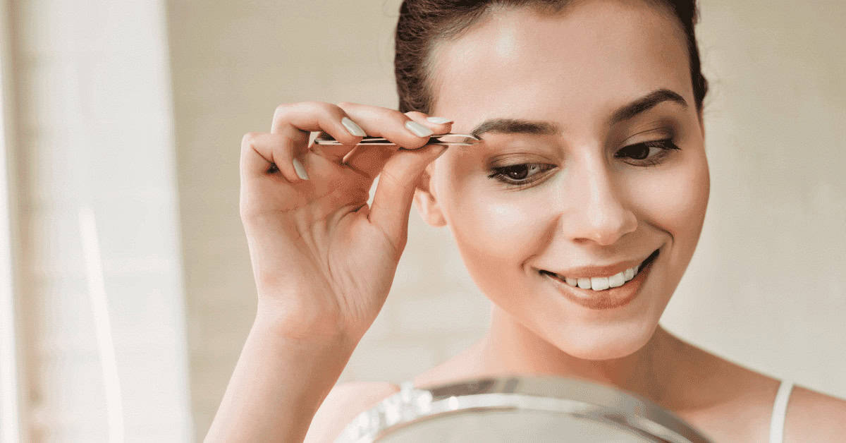 Eyebrow grooming, woman using tweezers for eyebrow shaping, eye makeup beauty routine, close-up of female makeup application, makeup artist enhancing eyebrows.