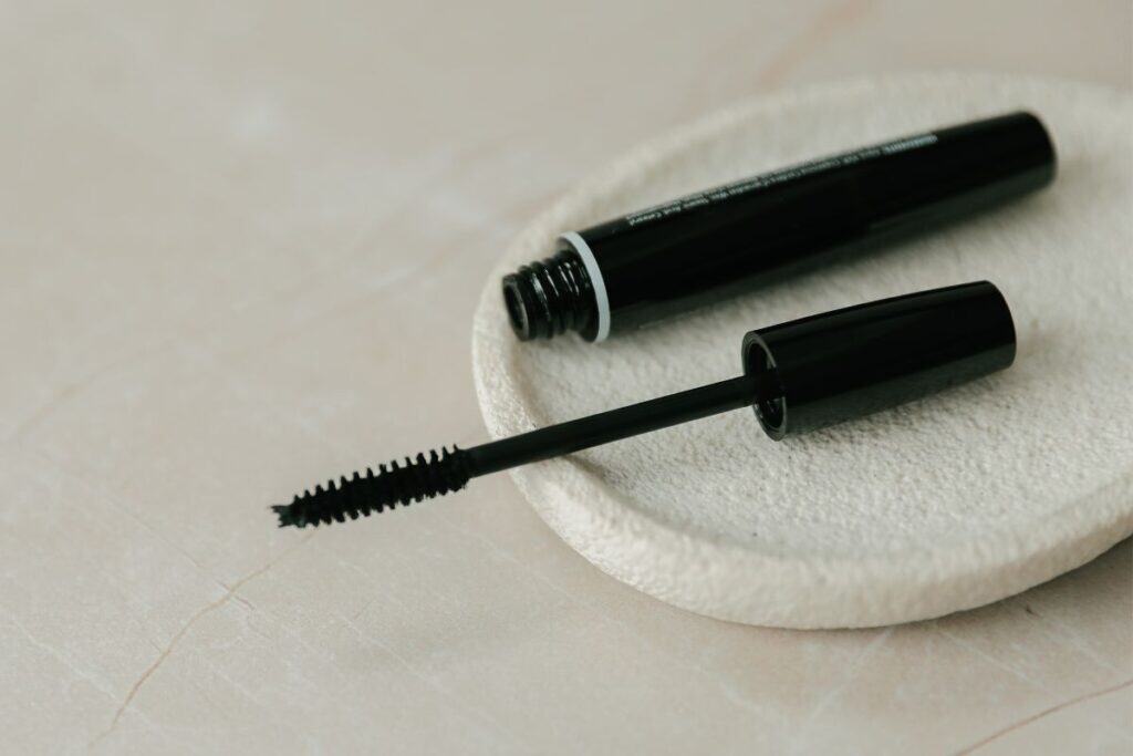 Black tubing mascara tube and wand, showing polymer-based formula designed for clump-free length and no smudging