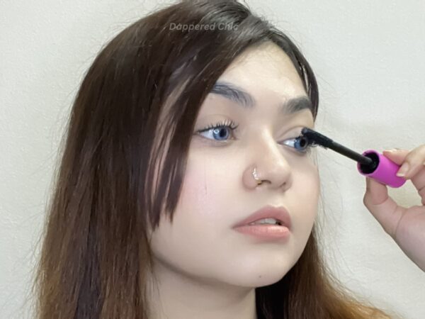 Applying tubing mascara from the lash root to the tip.