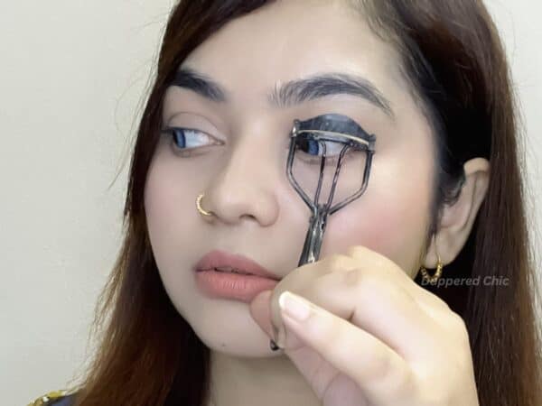 Curling lashes and wiping tubing mascara wand before use